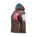 The Peak Performance Womens Helium Utility Down Hood Jacket is a brown hooded puffer with blue lining, light pink pockets on the chest and sleeves, blue zipper pulls, and a fitted silhouette—displayed from the side against a plain white background.