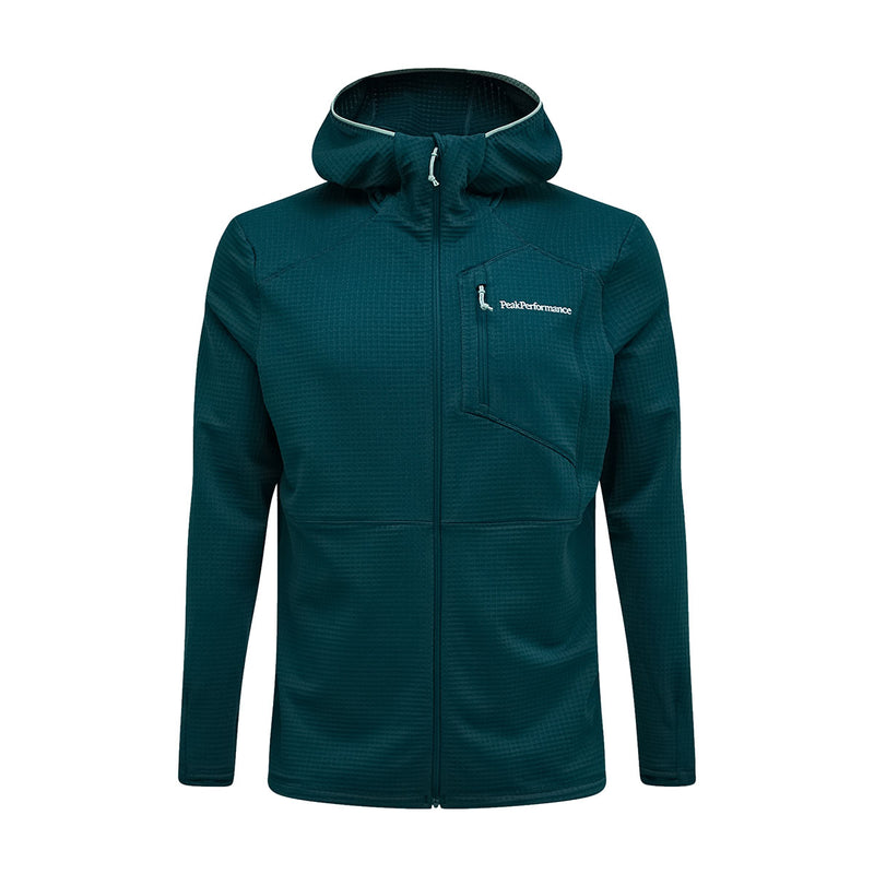 The Peak Performance Mens Trail Polartec Power Grid Zip Hooded Fleece is a teal jacket featuring a front zipper, chest pocket, and the Peak Performance logo on the left chest. Designed with long sleeves and a fitted silhouette, this technical midlayer offers a power grid zip hood, making it an ideal choice for active pursuits.