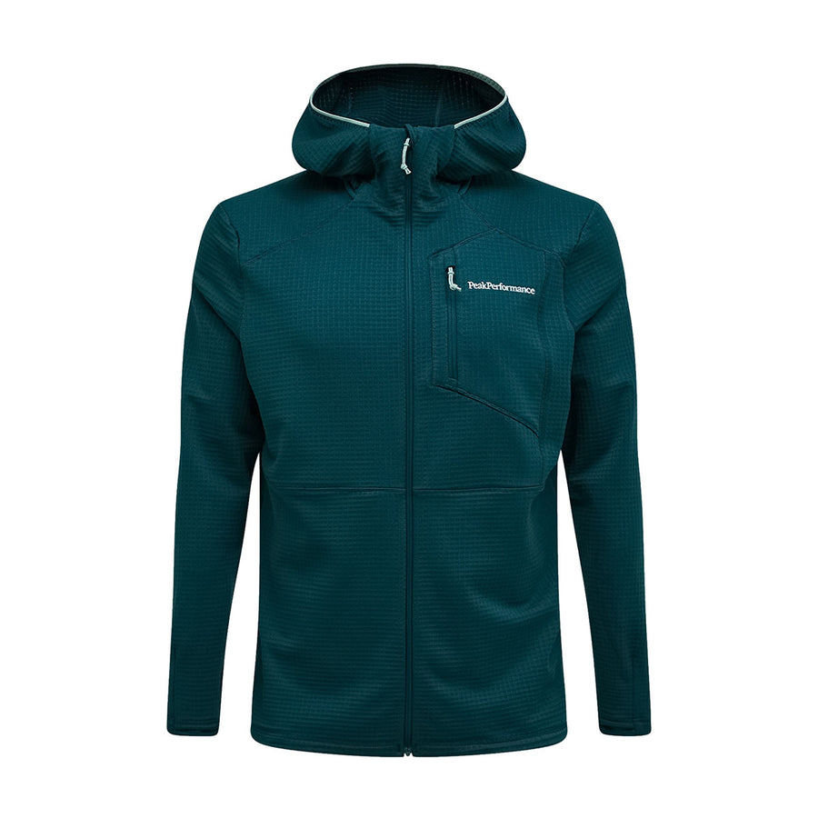 The Peak Performance Mens Trail Polartec Power Grid Zip Hooded Fleece is a teal jacket featuring a front zipper, chest pocket, and the Peak Performance logo on the left chest. Designed with long sleeves and a fitted silhouette, this technical midlayer offers a power grid zip hood, making it an ideal choice for active pursuits.