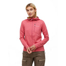 A woman with long blonde hair wears the Peak Performance Womens Trail Polartec Power Grid Zip Hooded Fleece in pink and brown pants, standing against a plain white background with her hands held together.