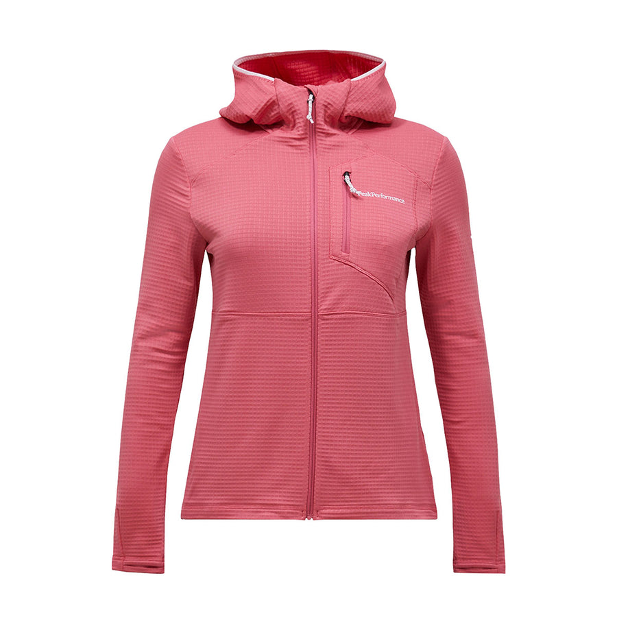 The Peak Performance Womens Trail Polartec Power Grid Zip Hooded Fleece is a pink midlayer jacket designed for women, featuring Polartec Power Grid fleece, a front zipper, long sleeves, a chest pocket, and a small white logo on the left chest, displayed against a plain white background.
