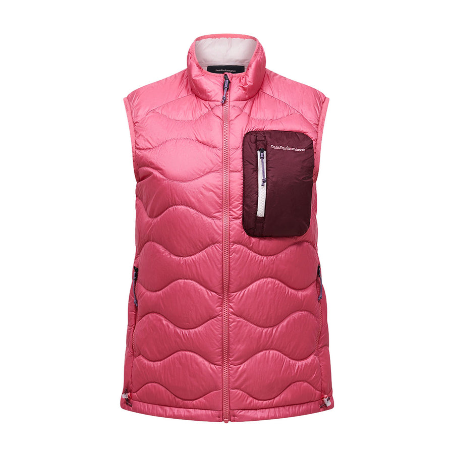 The Peak Performance Womens Helium Utility Down Vest is a sleeveless pink puffer vest featuring a front zipper and a contrasting maroon zippered chest pocket. Displayed against a white background, this stylish and functional utility vest offers lightweight, packable down warmth and convenient versatility for any occasion.