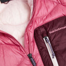 Close-up of a pink and maroon jacket with a white zipper and Peak Performance logo on the chest pocket. The jacket is partially unzipped to reveal a light-colored inner lining—perfect for layering over the Womens Helium Utility Down Vest by Peak Performance on brisk days.