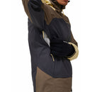 A person wearing the Peak Performance Mens Vislight GORE-TEX C-Knit 3L Shell Jacket in brown, tan, and black with yellow zippers is unzipping a side pocket while wearing black gloves; the persons face is partially out of frame.