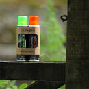Two bottles of Grangers clothing repel and clothing wash on a wooden surface with a natural background.