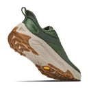 The Hoka Mens Transport 2 athletic shoe is displayed from a low rear angle against a white background, emphasizing its green and tan colorway, sustainable cushioned textured sole, and mesh upper—features that make this city-to-trail running shoe an ideal choice.