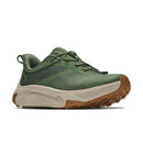 The Hoka Mens Transport 2 is a green athletic sneaker crafted with mesh and synthetic accents, designed with sustainable cushioning for all-day comfort. It features a beige midsole and a brown textured outsole. Inspired by city-to-trail running, the shoe is showcased against a white background.