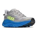 The Hoka Mens Challenger 8 Trail Running Shoe is pictured at a three-quarter side angle against a white background, featuring gray with blue and neon yellow accents, a thick blue sole, and black tread—making it an ideal choice for trail runners looking for cushioned, all-terrain performance.