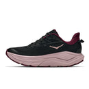 The Hoka Womens Challenger 8 Trail Running Shoe is a black athletic runner, featuring a thick, light pink cushioned midsole and maroon accents. Designed for road-to-trail adventures, it is shown in profile on a white background.