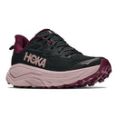 The Womens Challenger 8 Trail Running Shoe by Hoka features a black mesh upper, a light pink cushioned midsole, and maroon accents on the outsole, heel, and laces. Designed as a versatile road-to-trail option, this shoe showcases a large HOKA logo on the side.