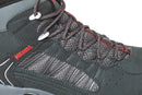 Close-up of the Meindl Mens Journey Mid GTX boot in dark grey, featuring red and black laces, mesh panels, Gore-Tex waterproof lining, metal eyelets, detailed stitching, and a Comfort Sport sole with Meindl in red on the side.