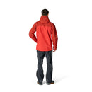 A person stands facing away against a plain white background, wearing the Rab Mens Latok Mountain GORE-TEX Pro Jacket in red and dark pants.