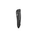 A black Leatherman Skeletool® KB Knife is shown folded, displaying its brand name and round handle cutouts. This everyday carry knife features a 420HC stainless steel blade, isolated on a white background.