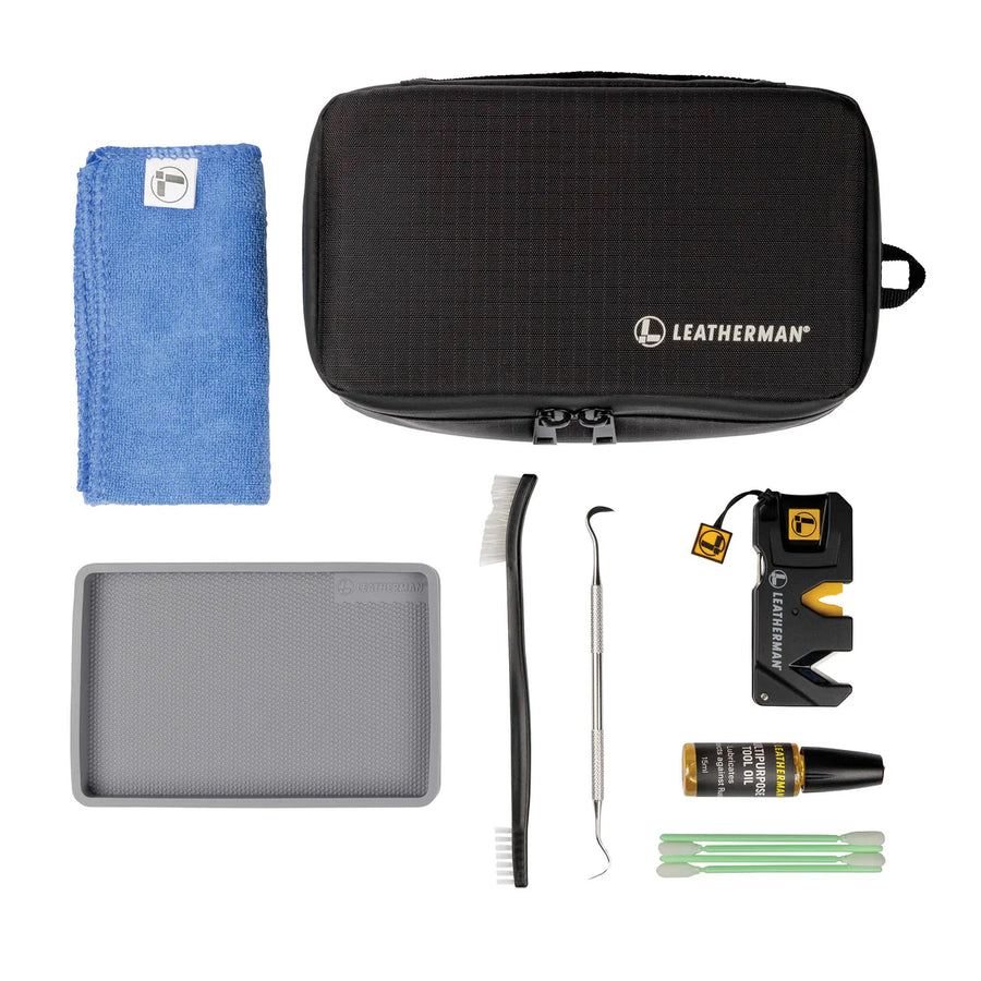 The Leatherman Tool Maintenance Kit includes a black zippered case, blue cloth, gray mat, brush, pick, yellow-accented tool, cleaning solution, and green-tipped swabs—everything needed for multi-tool care.