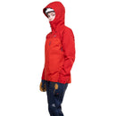 A child wearing a bright red hooded outdoor jacket, dark navy pants, and tan gloves, standing against a plain white studio background.