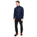 A man wearing the Mountain Equipment Men’s Jorasses Lite Fleece Jacket in navy blue, paired with black pants and orange-black shoes, stands facing slightly left and looks away from the camera against a plain white background.