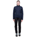 A person wears a navy blue Mountain Equipment Women’s Jorasses Lite Fleece Jacket and black pants.