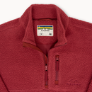 Close-up of a red fleece quarter-zip pullover with a stand collar, showing the brand label inside the neck and a subtle logo on the lower right chest.