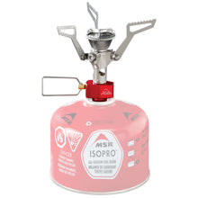The MSR PocketRocket 2 Stove is a portable and compact camping stove that features a durable metal burner attached to a red and white MSR IsoPro fuel canister. Designed for ultralight backpacking, this stove has foldable arms and an adjustable flame valve, making it perfect for quickly boiling meals during your outdoor adventures.