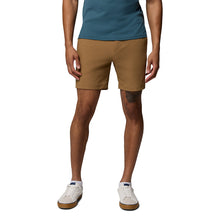 A person stands against a white background, wearing a teal shirt, Columbia Mens ROC Tech Shorts, and white sneakers. The image is cropped from the shoulders down, displaying their torso, legs, and feet.