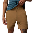 A person in tan Columbia Mens ROC Tech Shorts lifts a teal shirt to reveal the waistband, highlighting the shorts stretch comfort and water-repellent fabric with a focus on the lower torso.