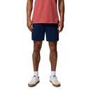 A person wearing a red T-shirt, Columbia Mens ROC Tech Shorts in navy blue, white socks, and white sneakers stands against a plain white background. The image is cropped at the shoulders.