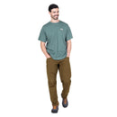 Model wearing Men’s Podus Tee green standing front