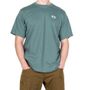 Model wearing Men’s Podus Tee green close-up chest logo