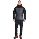 Man wearing a black Rab jacket and pants on a white background