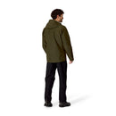 A man stands facing away, wearing the Rab Mens Namche GTX Waterproof Jacket in dark green and black pants. This GORE-TEX hiking shell is crafted from recycled fabric, set against a plain white background.