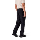 A person wearing a light beige short-sleeve shirt, Rab Mens Namche Hike GORE-TEX Pants in black, and black shoes stands facing away with arms relaxed against a plain white background.