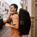 Osprey Farpoint Fairview Wheeled Travel Pack 65L worn, back view, Black