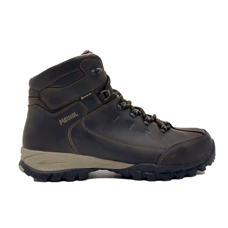 A single Meindl Mens Trento GTX Walking Boot in dark brown leather with black laces, metal eyelets, and a rugged black and gray sole is shown from the side against a white background.