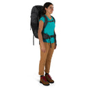 Osprey Rook 50 Backpack worn, full length side profile, Dark Charcoal/Silver