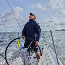 Man wearing Helly Hansen crew midlayer jacket on a boat