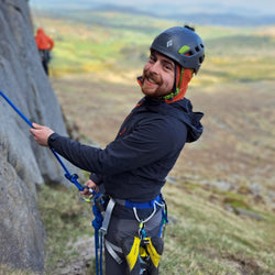 Shane Carolan, Great Outdoors Staff member having a great time belaying a friend.