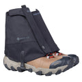A pair of tan and black hiking shoes with thick soles are equipped with Trekmates Glenmore GORE-TEX Ankle Gaiters, which cover the ankles and uppers for enhanced trail protection and feature branded details.