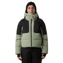 Person wearing a two-tone green and black puffer jacket with a hood on a light gray background