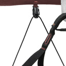 Close-up of a black strap with red accents attached to a harness on a white background