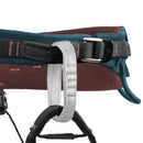 Close-up of a climbing harness with multiple straps on a white background