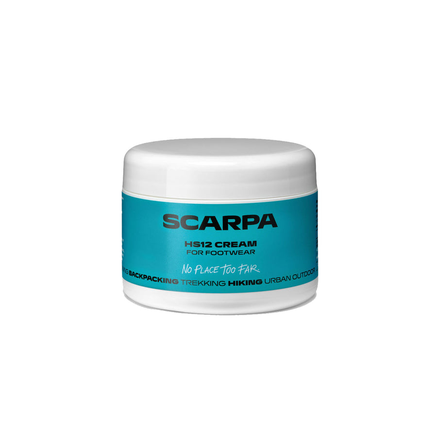 A white jar with a blue label reading “Scarpa HS12 Footwear Cream” stands on a white background. The label states that it is intended for backpacking, trekking, and hiking, and emphasizes its effectiveness as a silicone-based cream specially formulated to waterproof leather—including full-grain leather.