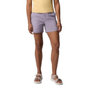 A person models Columbia Womens Cedar Crest Hiking Shorts in light purple with a yellow top and white sandals, standing against a plain white background. The photo is cropped at the shoulders, arms relaxed at their sides.