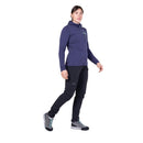Model wearing purple hooded jacket, walking side profile