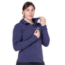 Model wearing purple hooded jacket, adjusting collar