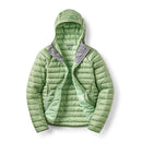 The Rab Womens Microlight Alpine Hoody is a light green, puffy alpine jacket featuring a gray inner collar, shown unzipped to reveal its interior lining and convenient side pockets. This stylish women’s down hoody is packable and insulated, making it perfect for layering in changing weather conditions.