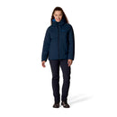 A woman stands facing forward, smiling, wearing the Rab Womens Microlight Shield Waterproof Down Jacket, featuring Pertex Shield technology, paired with black pants and black shoes against a plain white background.