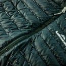 Close-up of a quilted jacket with water droplets and 'Kathmandu' branding.