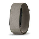 A side view of the Garmin CIRQA Smart Band in beige woven material, with its watch face partly hidden by the sleek band—perfect for those wanting around-the-clock health monitoring in a stylishly subtle design.