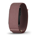 A close-up of the Garmin CIRQA Smart Band with a textured, dusty pink fabric strap—shown from the side on a plain white background—highlights its advanced sleep tracking and round-the-clock health monitoring features.