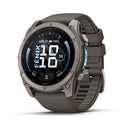 A rugged Garmin fēnix 9 multisport GPS smartwatch in black and gray features a round AMOLED display showing the date, time, battery level, steps, and heart rate. It comes with a durable rubber wristband.